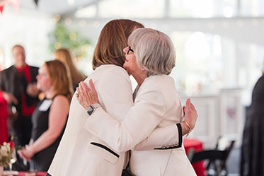 Two women embrace each other. Links to Gifts from Retirement Plans Two women embrace each other. Links to Gifts from Retirement Plans
