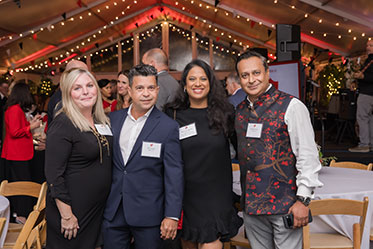 Four people standing together at an event. Links to Donor-Advised Funds Four people standing together at an event. Links to Donor-Advised Funds