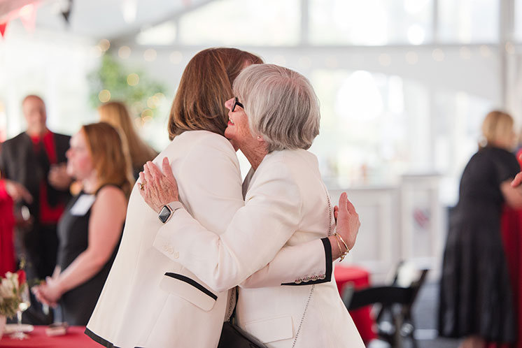 Two women embrace each other. Links to Gifts from Retirement Plans Two women embrace each other. Links to Gifts from Retirement Plans